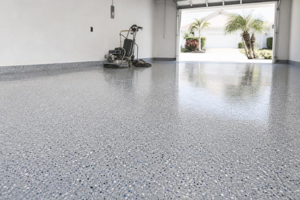 Glossy epoxy floor coating in a Bonita Springs residential garage with decorative flakes and professional finish